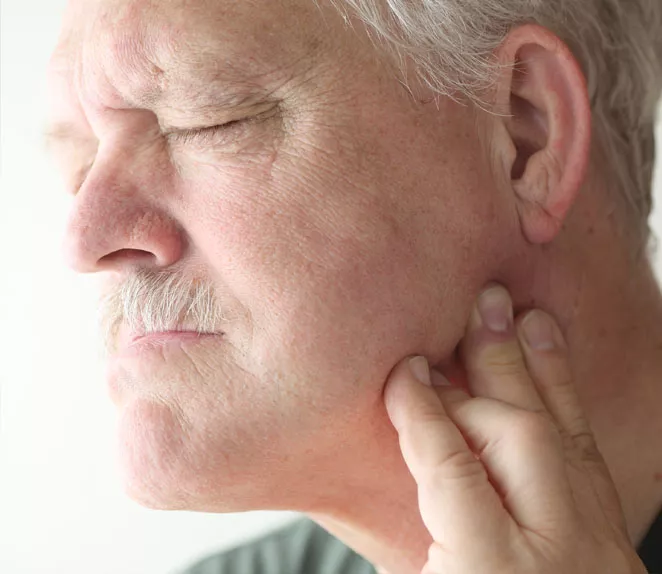 Man experiencing jaw pain